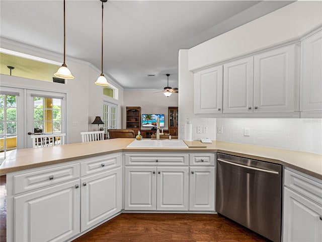 kitchen featuring a peninsula, white cabinets, light countertops, dishwasher, and decorative light fixtures