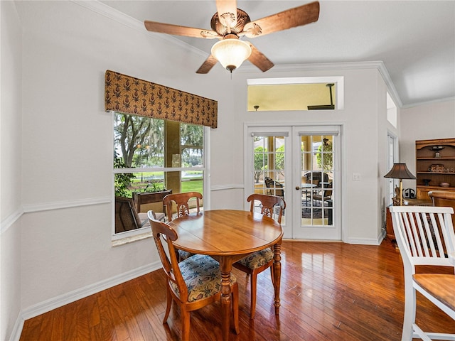 dining area with dark wood-style floors, french doors, crown molding, ceiling fan, and baseboards