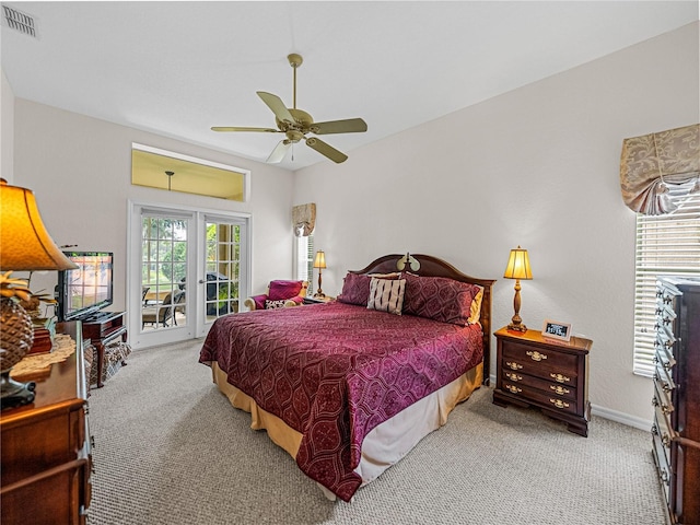 carpeted bedroom featuring access to exterior, visible vents, ceiling fan, and baseboards