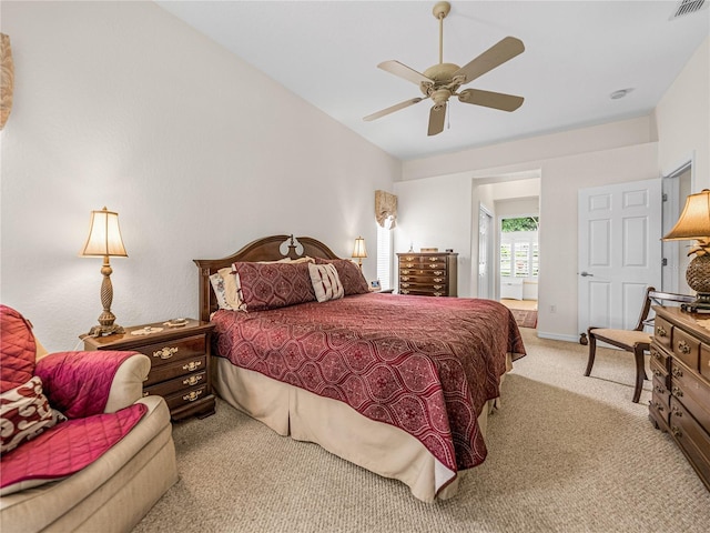 bedroom with a ceiling fan, light colored carpet, and visible vents