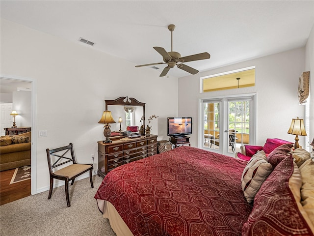 carpeted bedroom featuring access to exterior, visible vents, baseboards, and a ceiling fan