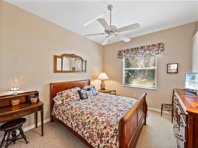 bedroom with light carpet, ceiling fan, and baseboards