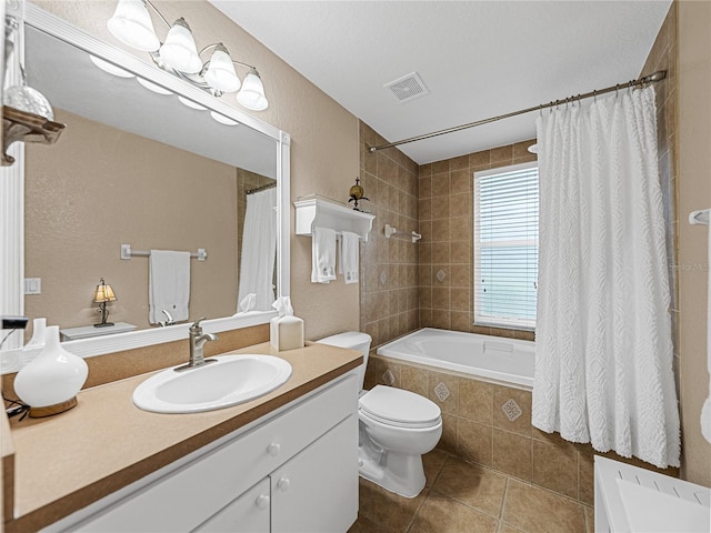 bathroom with toilet, vanity, and tile patterned flooring