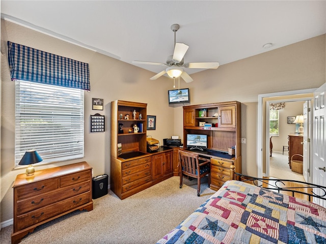 bedroom with a ceiling fan and light colored carpet