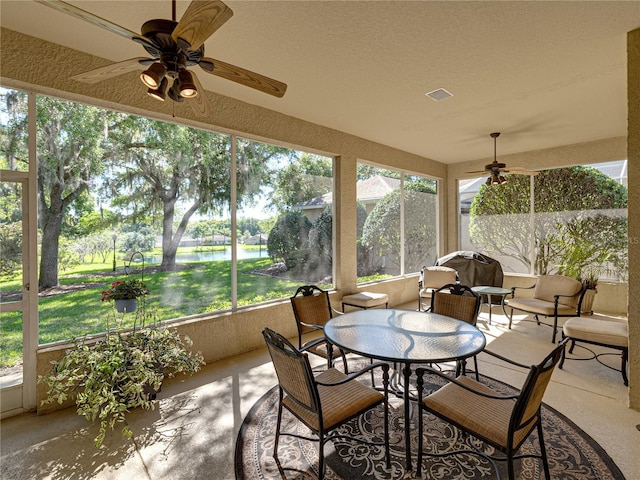 sunroom with visible vents and a ceiling fan