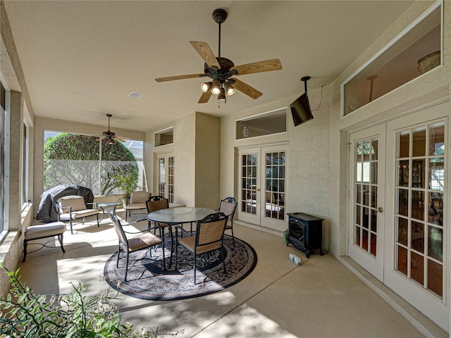 sunroom with ceiling fan, french doors, and visible vents