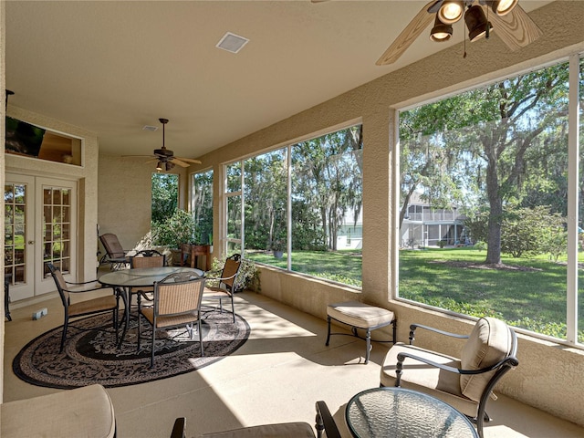 sunroom with visible vents, french doors, and a ceiling fan