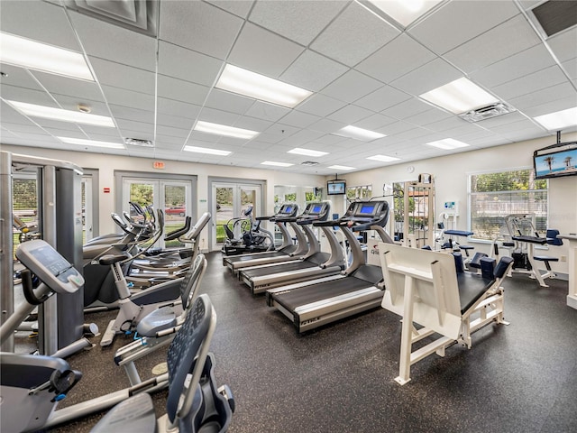 workout area with french doors, a paneled ceiling, and visible vents