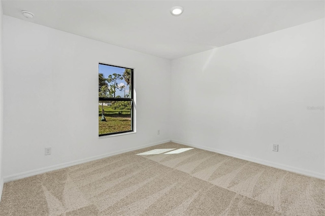 unfurnished room with light colored carpet