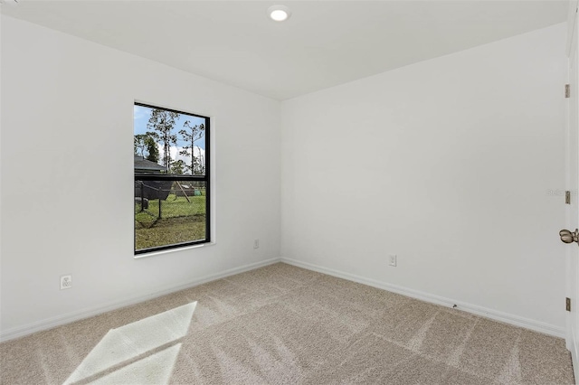 unfurnished room with light carpet