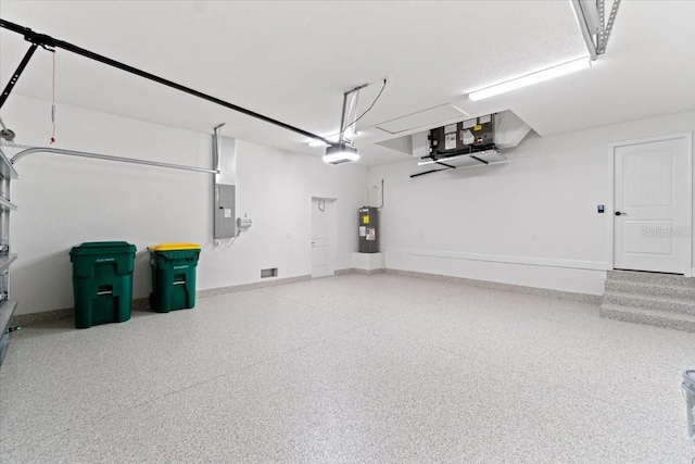 garage featuring a garage door opener, electric panel, and electric water heater