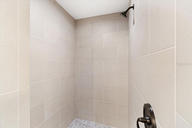 bathroom with a tile shower