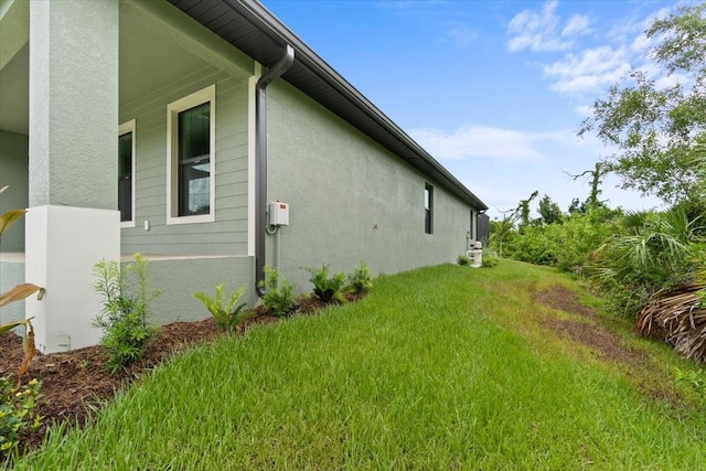 view of side of property with a yard