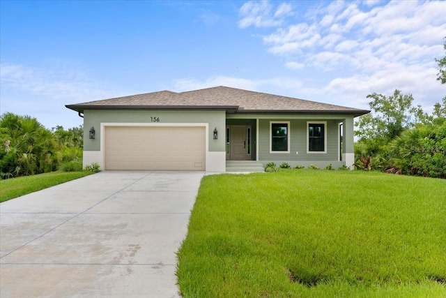 view of front of house with a garage and a front lawn