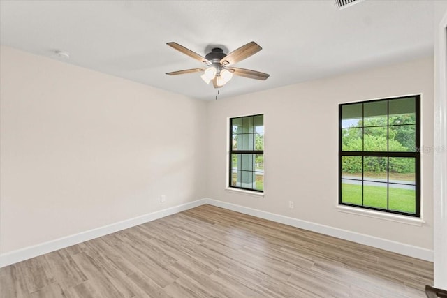 spare room with ceiling fan and light hardwood / wood-style flooring