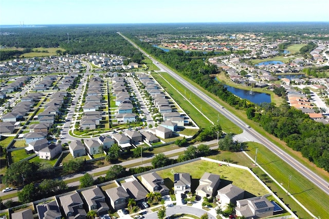 birds eye view of property with a water view and a residential view