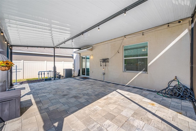 view of patio / terrace featuring fence and central AC unit