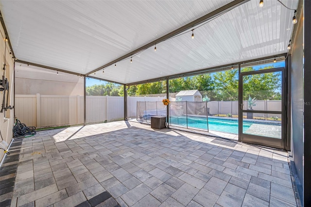 unfurnished sunroom featuring track lighting