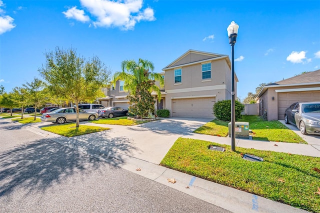 view of front of home featuring driveway, stucco siding, a garage, and a front yard