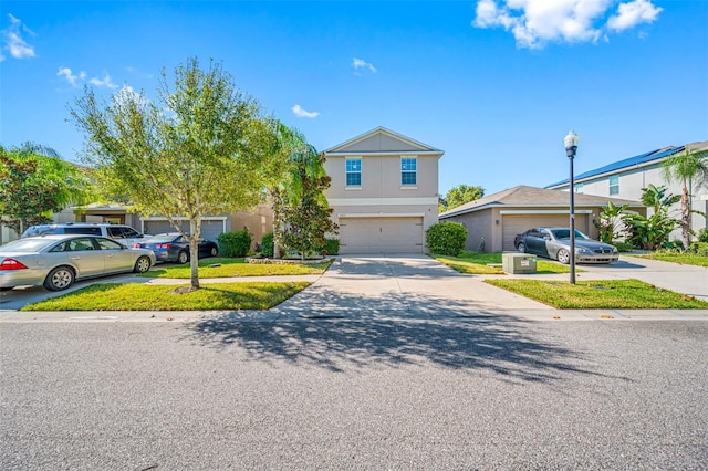 view of front of property featuring driveway, a garage, and stucco siding