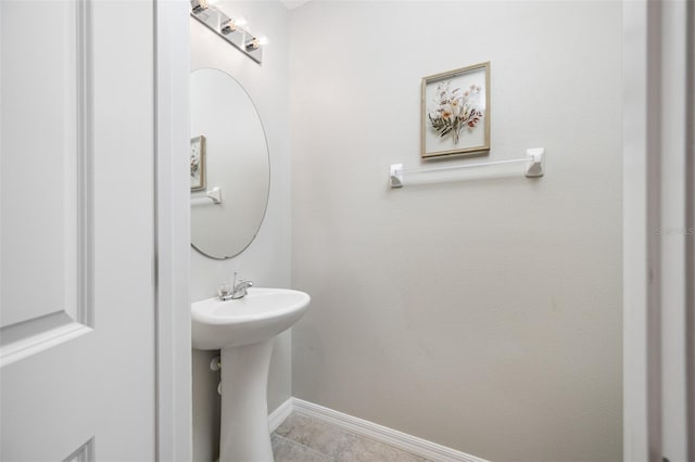 bathroom with tile patterned flooring and baseboards