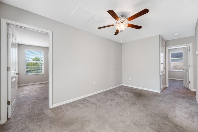 unfurnished bedroom featuring a textured ceiling, carpet flooring, a ceiling fan, and baseboards