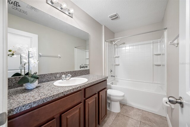 bathroom featuring toilet, tile patterned floors, tub / shower combination, a textured ceiling, and vanity