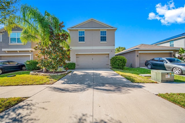 view of front of property featuring a garage, concrete driveway, and stucco siding