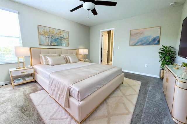 bedroom featuring a ceiling fan, carpet, and baseboards