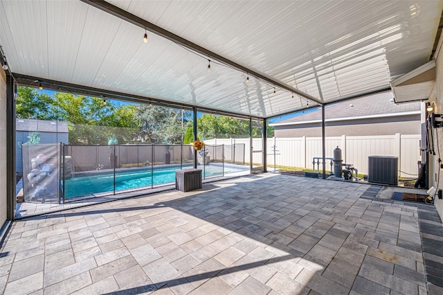 view of patio / terrace featuring central AC, a fenced backyard, and a fenced in pool