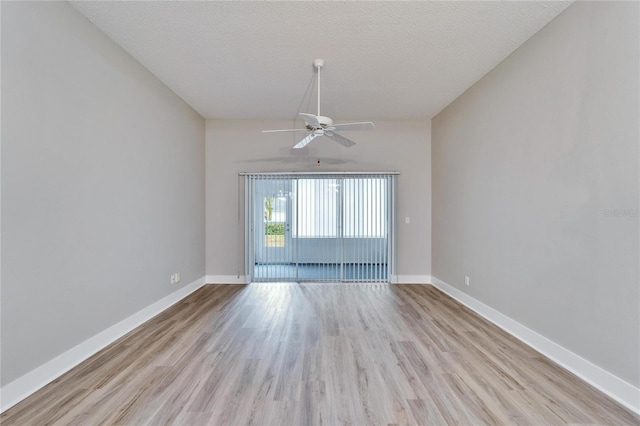 spare room with ceiling fan, light hardwood / wood-style floors, and a textured ceiling