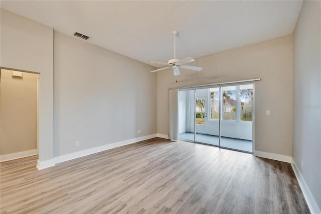 spare room with ceiling fan, light hardwood / wood-style floors, and a textured ceiling