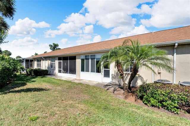 rear view of property with a yard