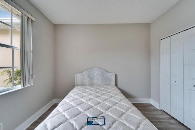 bedroom featuring a closet and dark wood-type flooring