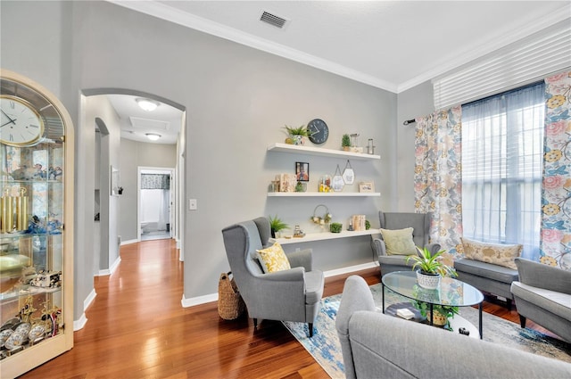 living room featuring ornamental molding and wood-type flooring