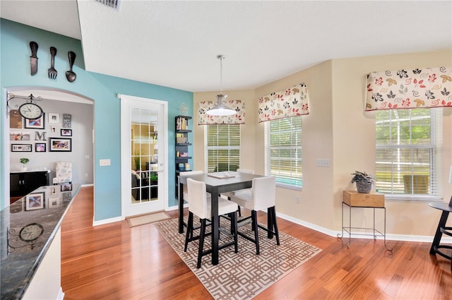 dining space with plenty of natural light and light hardwood / wood-style flooring