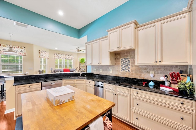 kitchen with decorative light fixtures, ceiling fan, light hardwood / wood-style flooring, dishwasher, and sink