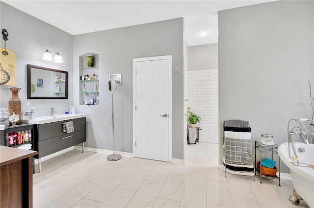 bathroom featuring tile flooring, a bath, and vanity