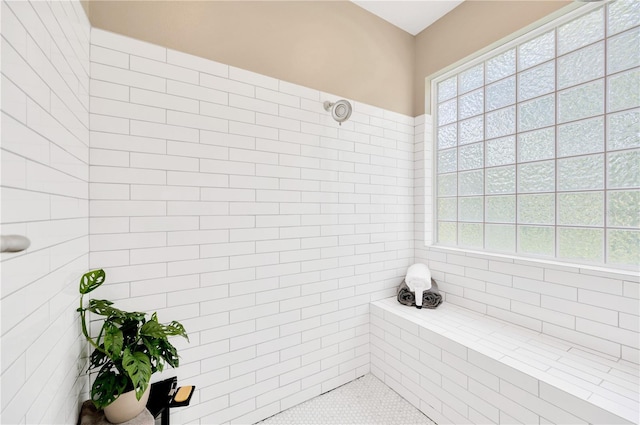 bathroom with a tile shower