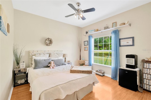 bedroom with ceiling fan and light hardwood / wood-style flooring