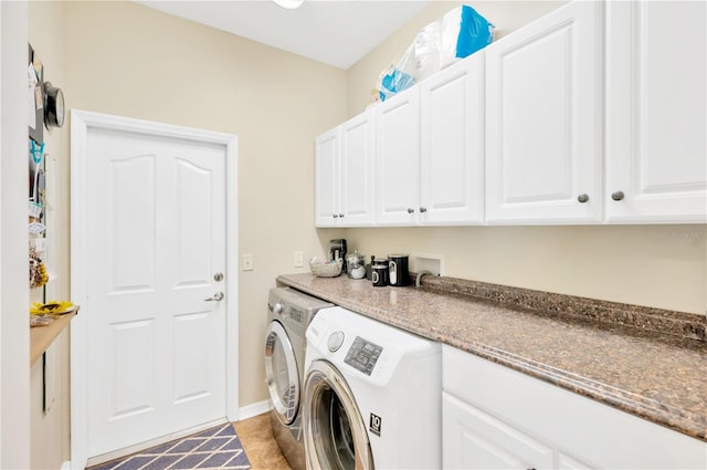 washroom featuring washer and dryer, hookup for a washing machine, light tile floors, and cabinets