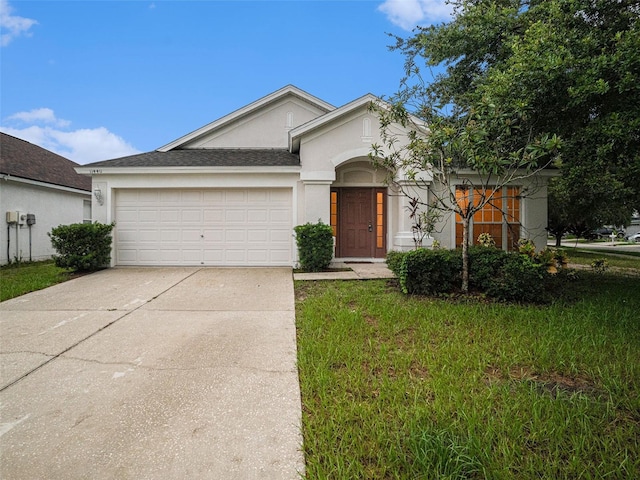 view of front of property featuring roof with shingles, stucco siding, concrete driveway, an attached garage, and a front yard