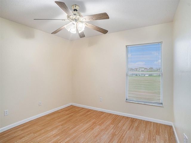 unfurnished room with a ceiling fan, light wood-type flooring, and baseboards