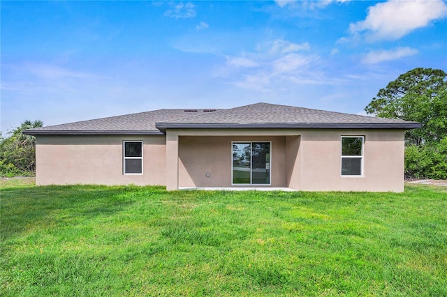 rear view of property with a yard