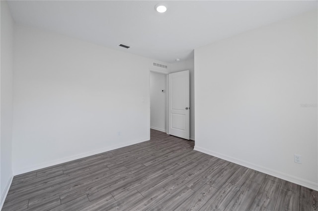 unfurnished room with dark hardwood / wood-style flooring