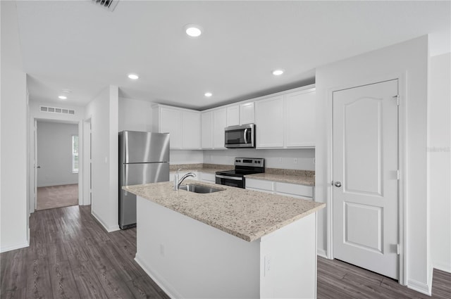 kitchen with an island with sink, stainless steel appliances, white cabinetry, and sink