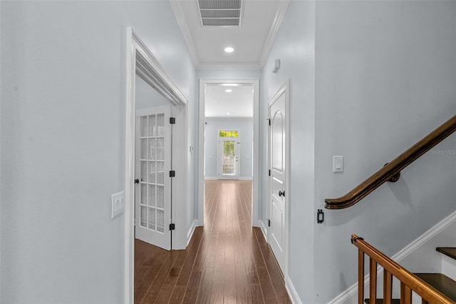 corridor with dark hardwood / wood-style floors and crown molding