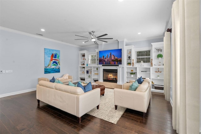 living room featuring dark hardwood / wood-style floors, ceiling fan, and ornamental molding