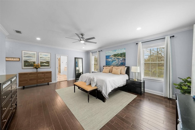 bedroom with connected bathroom, crown molding, ceiling fan, and dark wood-type flooring