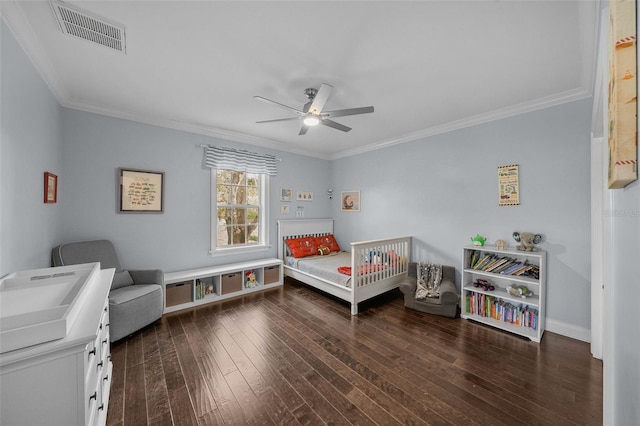 bedroom featuring ornamental molding, ceiling fan, and dark wood-type flooring